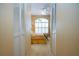 A view through a hallway reveals a bedroom with bright windows and matching white closets at 542 Princeton Greens Ct # 21, Sun City Center, FL 33573