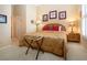 A bright bedroom features a cozy bed with decorative pillows and a dark-wood bedside table at 542 Princeton Greens Ct # 21, Sun City Center, FL 33573