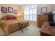 Warm and inviting bedroom with large arched windows, dresser and warm colors at 542 Princeton Greens Ct # 21, Sun City Center, FL 33573