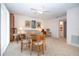 Bonus room with dining table, sofa, and ceiling fan at 542 Princeton Greens Ct # 21, Sun City Center, FL 33573