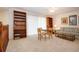 Bonus room features two bookcases, a dining table, and a plaid sofa at 542 Princeton Greens Ct # 21, Sun City Center, FL 33573