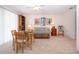 Bonus room with dining table, sofa, and decorative wall art at 542 Princeton Greens Ct # 21, Sun City Center, FL 33573