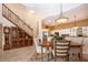 Dining room leading to a modern kitchen, featuring a staircase and display cabinet at 542 Princeton Greens Ct # 21, Sun City Center, FL 33573