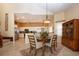 Open dining area with an elegant chandelier and views to kitchen and staircase at 542 Princeton Greens Ct # 21, Sun City Center, FL 33573
