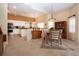Dining area with a chandelier and seamless access to the kitchen at 542 Princeton Greens Ct # 21, Sun City Center, FL 33573