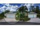 Charming single-story home featuring a well-manicured lawn, a circular driveway, and a symmetrical design at 542 Princeton Greens Ct # 21, Sun City Center, FL 33573