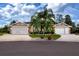 Charming single-story home featuring a well-manicured lawn, a circular driveway, and a symmetrical design at 542 Princeton Greens Ct # 21, Sun City Center, FL 33573