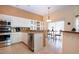 Well-lit kitchen with granite countertops and stainless steel appliances at 542 Princeton Greens Ct # 21, Sun City Center, FL 33573