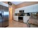 Kitchen with stainless steel appliances, granite countertops, and white cabinets at 542 Princeton Greens Ct # 21, Sun City Center, FL 33573