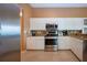 Kitchen showcasing stainless steel appliances, granite countertops, and white cabinets at 542 Princeton Greens Ct # 21, Sun City Center, FL 33573