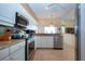 Kitchen with granite countertops, white cabinets, stainless steel appliances and tile flooring at 542 Princeton Greens Ct # 21, Sun City Center, FL 33573
