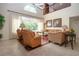 This living room has tile floor, a fan, lots of light and an open staircase at 542 Princeton Greens Ct # 21, Sun City Center, FL 33573