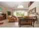 The living room features tile floors, a fan, large window and high ceilings at 542 Princeton Greens Ct # 21, Sun City Center, FL 33573