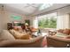 This living room features tile flooring, a large window, and an open staircase at 542 Princeton Greens Ct # 21, Sun City Center, FL 33573