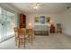 Cozy living space with a table, sofa, and access to an outdoor balcony for relaxation at 542 Princeton Greens Ct # 21, Sun City Center, FL 33573