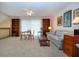 Comfortable living room with a ceiling fan, bookshelves, and neutral carpet and decor at 542 Princeton Greens Ct # 21, Sun City Center, FL 33573