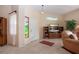 The living room features tile flooring, a decorative window and a tv at 542 Princeton Greens Ct # 21, Sun City Center, FL 33573