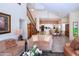 Open-concept living room with staircase and a view of the kitchen and dining area at 542 Princeton Greens Ct # 21, Sun City Center, FL 33573