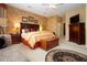 Main bedroom showcasing a bed with patterned pillows, a patterned chaise lounge, and a television at 542 Princeton Greens Ct # 21, Sun City Center, FL 33573