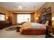 Cozy main bedroom with a large bed, bay window, dark wood furniture, and patterned area rug at 542 Princeton Greens Ct # 21, Sun City Center, FL 33573