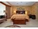 Large main bedroom featuring a king-sized bed, textured walls, and neutral carpet at 542 Princeton Greens Ct # 21, Sun City Center, FL 33573