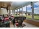 Enclosed patio with wicker furniture, ceiling fan, and a view of the tranquil backyard at 542 Princeton Greens Ct # 21, Sun City Center, FL 33573