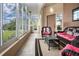 Enclosed patio with tile floor, wicker furniture, and views of pond at 542 Princeton Greens Ct # 21, Sun City Center, FL 33573