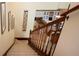 Carpeted staircase leading to an upper level with hardwood floors and a view of the kitchen at 542 Princeton Greens Ct # 21, Sun City Center, FL 33573