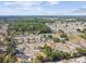 Wide aerial view highlighting neighborhood with mature trees, surrounding landscapes, and homes at 5628 Mccoy Ct, Zephyrhills, FL 33542