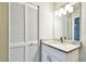 Bathroom with a white vanity, granite countertop, framed mirror and decorative lights at 5628 Mccoy Ct, Zephyrhills, FL 33542