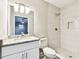 This renovated bathroom features a granite vanity, a large mirror, and a walk-in shower at 5628 Mccoy Ct, Zephyrhills, FL 33542