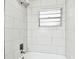Bright, updated bathroom with a tiled shower/tub, and a window for natural light at 5628 Mccoy Ct, Zephyrhills, FL 33542
