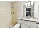 This well-lit bathroom features a shower stall and a vanity with granite countertop at 5628 Mccoy Ct, Zephyrhills, FL 33542