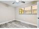 This cozy bedroom features wood flooring, natural light from the window, and a ceiling fan at 5628 Mccoy Ct, Zephyrhills, FL 33542