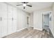 Bedroom with hardwood floors, ceiling fan, closet and lots of natural light at 5628 Mccoy Ct, Zephyrhills, FL 33542