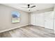 Bedroom featuring modern ceiling fan, wood floors, and a bright window view at 5628 Mccoy Ct, Zephyrhills, FL 33542