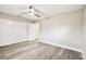 Bright bedroom features a ceiling fan, wood floors, and a large closet with paneled doors at 5628 Mccoy Ct, Zephyrhills, FL 33542
