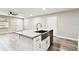 Bright open kitchen features new flooring, white cabinets, stainless steel appliances, and granite counters at 5628 Mccoy Ct, Zephyrhills, FL 33542