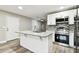 Updated kitchen showcases granite counters, a stainless sink, and modern appliances at 5628 Mccoy Ct, Zephyrhills, FL 33542