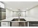 Bright kitchen features a spacious island with a stainless steel sink and modern faucet at 5628 Mccoy Ct, Zephyrhills, FL 33542