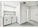 This functional laundry area features a washer and dryer and lots of shelving at 5628 Mccoy Ct, Zephyrhills, FL 33542