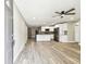 Open-concept living room flowing into the kitchen, featuring modern finishes and stainless steel appliances at 5628 Mccoy Ct, Zephyrhills, FL 33542