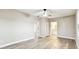 A large bedroom features lots of natural light, wood-look floors, and neutral paint at 5628 Mccoy Ct, Zephyrhills, FL 33542