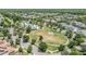 Aerial view of neighborhood with a large green space and mature trees at 5743 Skytop Dr, Lithia, FL 33547