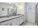 Bathroom with double vanity, granite countertops, and a glass-enclosed shower at 5743 Skytop Dr, Lithia, FL 33547