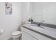 Bright bathroom featuring a sleek countertop, modern fixtures, and a commode at 5743 Skytop Dr, Lithia, FL 33547