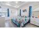 Bright bedroom with tray ceiling, natural light, and blue accent decor and bedding at 5743 Skytop Dr, Lithia, FL 33547
