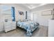 Bright bedroom with tray ceiling, natural light, and blue accent decor and bedding at 5743 Skytop Dr, Lithia, FL 33547