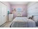 Charming bedroom with lilac walls, stylish stripes, and soft, comforting décor at 5743 Skytop Dr, Lithia, FL 33547