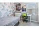 Cozy ' bedroom with grey walls, geometric pink accents, desk, and light laminate flooring at 5743 Skytop Dr, Lithia, FL 33547